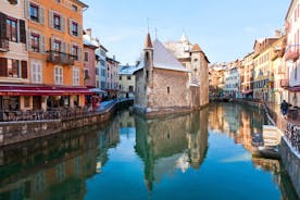 photo of Annecy city center panoramic aerial view with the old town, castle, Thiou river and mountains surrounding the lake, beautiful summer vacation tourism destination in France, Europe.