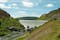 Photo of the waters flowing over the top of the main dam at Caban Coch dam in the Elan valley of Wales.