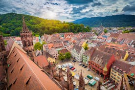 Photo of aerial view of the historic city center of Freiburg im Breisgau from famous old Freiburger Minster in beautiful evening light at sunset, Germany.