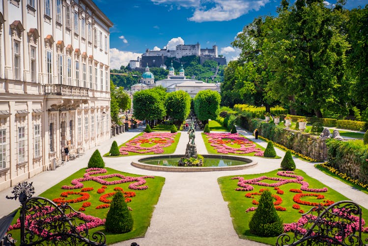 Photo of Mirabell Palace and Gardens in Summer, Salzburg castle in background.