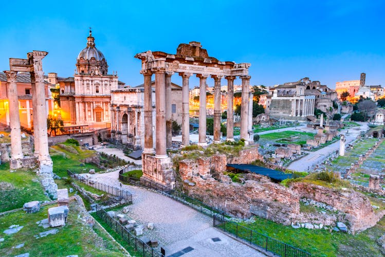 Rome, Italy. Stunning twilight view of Forum ancient ruins, seen from Capitoline hill with Colosseum in background.