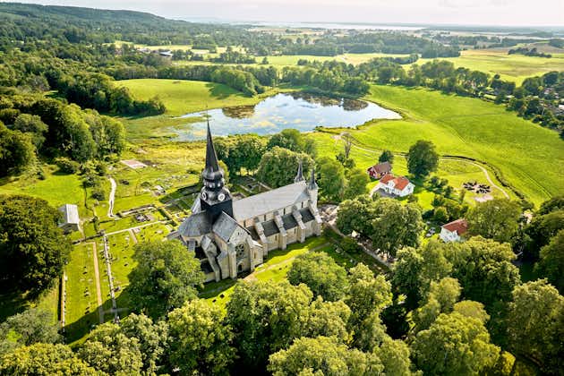 photo of aerial view of Varnhem Abbey with the adjacent monastery lake in Varnhem, Sweden.
