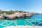 photo of the beautiful turquoise waters of Cala en Brut, Menorca beach, Balearic Islands, Spain.
