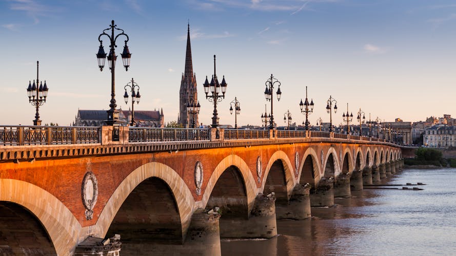 Photo of Pont de pierre at sunset in the famous winery region Bordeaux, France.
