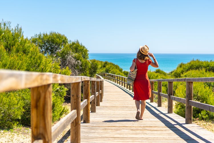 Photo of tourist on the wooden path to Playa Moncayo in Guardamar del Segura next to Torrevieja, Alicante. Community of Valencia.
