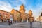 photo of Castle Estense (Castello Estense) and piazza Savonarola and monumet to Savonarola in Ferrara, Emilia-Romagna, Italy. Ferrara is capital of the Province of Ferrara