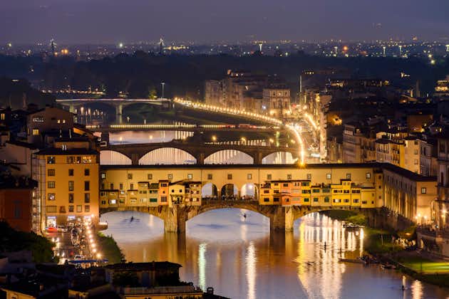 photo of ponte vecchio bridge over arno river at sunset, Florence, Italy.