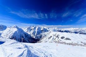Photo of aerial view of beautiful winter landscape of Les Deux Alpes surrounded by mountains, France.