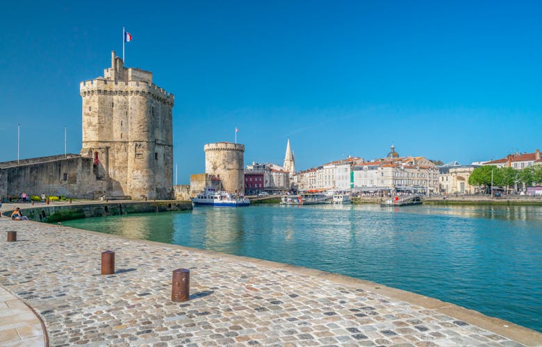 Photo of La Rochelle, France old harbour with medieval castle towers on Atlantic coast of Charente-Maritime.