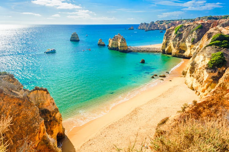 Photo of beautiful sandy beach near Lagos in Ponta da Piedade, Algarve region, Portugal.