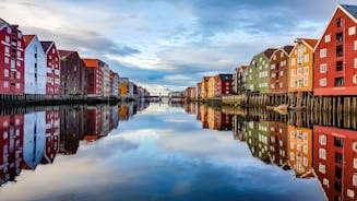 Photo of colorful old houses at the Nidelva river embankment in the center of Trondheim old town, Norway.