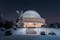 Silesian Planetarium during the blue hour. Beautiful winter scenery. The snow-covered dome of the observatory