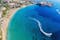 Photo of aerial panoramic beautiful view of Coral bay beach with jet ski and people having fun, Cyprus.