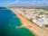 photo of an aerial view of wide sandy beach in touristic resorts of Quarteira and Vilamoura, Algarve, Portugal.
