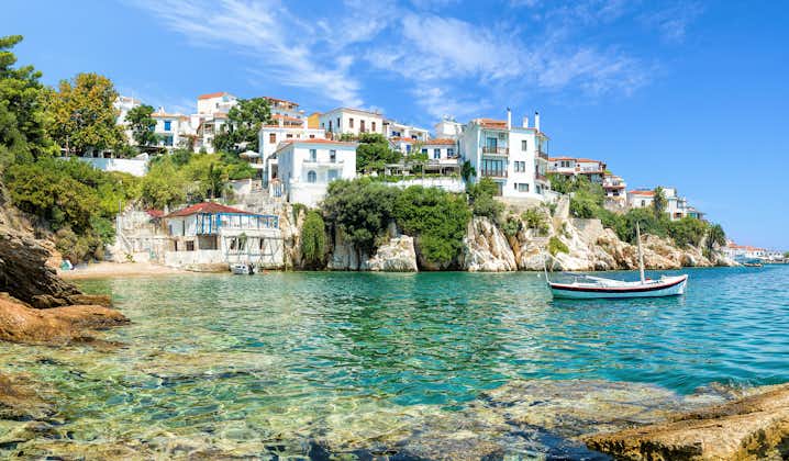 Photo of Skiathos old port with a blue sky and beautiful beach.