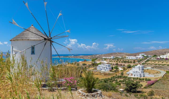 Photo of traditional Cycladitic view with whitewashed houses and a scenic windmill in Krotiri, Paros island, Greece.