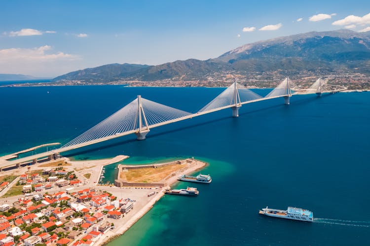 Photo of aerial view from a drone on a beautiful large bridge for a highway across the sea in Patras, Greece.