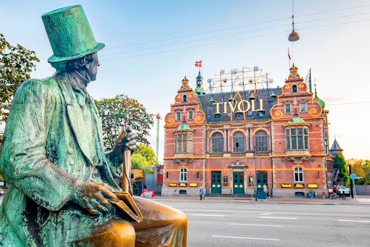 Photo of Hans Christian Andersen sculpture and entrance to Tivoli Garden park, Copenhagen, Denmark.