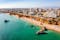 Photo of aerial view of touristic Portimao with wide sandy Rocha beach, Algarve, Portugal.