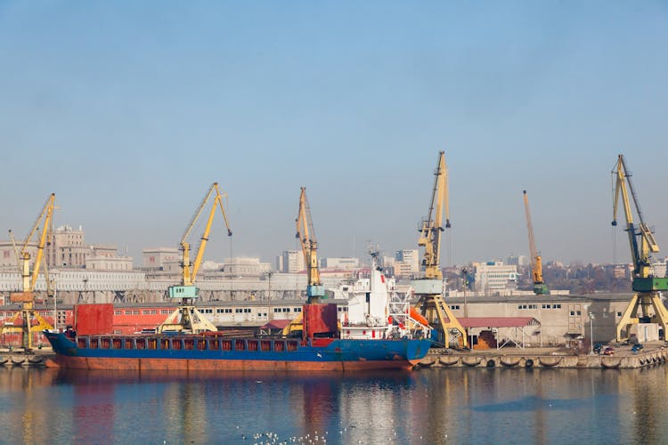 Seaport with cranes and moored dry cargo ship in Constanta Romania.