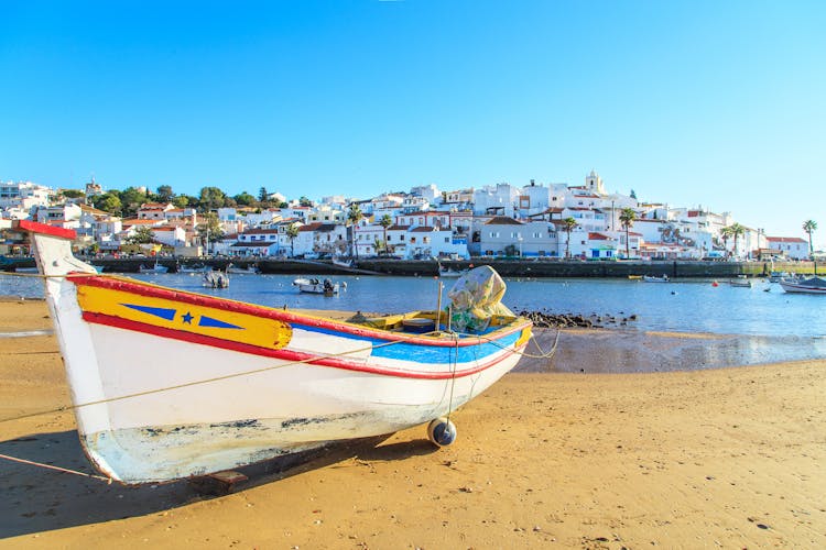 Photo of boat in warm sunset light on the beach in Portimao, Portugal