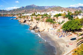 Photo of aerial view of the town of Nerja with the beautiful beach, Málaga, one of the white villages of Andalusia, Spain.