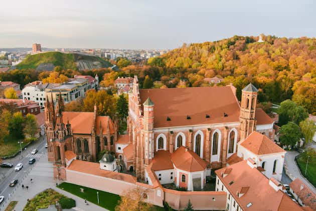 photo of aerial view of st. anne church and neighbouring bernardine church, one of the most beautiful and probably the most famous buildings in vilnius. Beautiful autumn day in the capital of Lithuania.