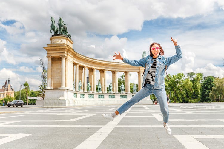 An Asian woman tourist on one of the main attractions of Budapest - Heroes Square. 