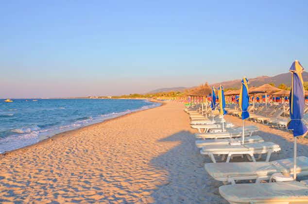 Photo of amazing Tigaki beach in Kos, Greece with rows of sun beds and umbrellas.