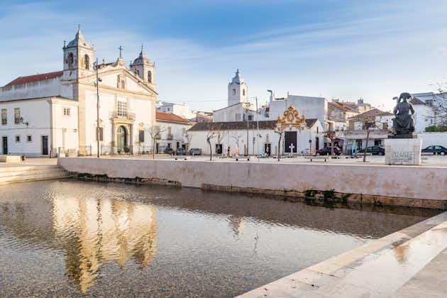 Lagos, Portugal - March 10, 2020: Square of Lagos city with cathedral in water reflection in Algarve, Portugal.