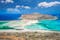 photo of view of Balos lagoon on Crete island, Greece. Tourists relax and bath in crystal clear water of Balos beach.,vMunicipality of Kissamos, Greece.