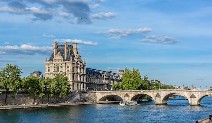 Photo of famous Louvre Museum from the Seine River. Louvre Museum is one of the largest and most visited museums worldwide, Paris, France.