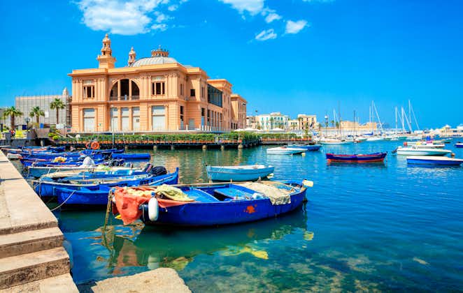 Margherita Theater and fishing boats in old harbor of Bari, Puglia, Italy. Bari is the capital city of the Metropolitan City of Bari on the Adriatic Sea, Italy. Architecture and landmark of Italy.