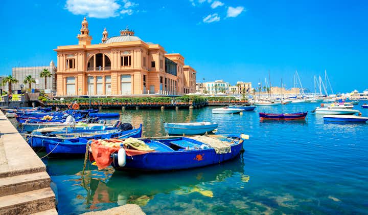 Margherita Theater and fishing boats in old harbor of Bari, Puglia, Italy. Bari is the capital city of the Metropolitan City of Bari on the Adriatic Sea, Italy. Architecture and landmark of Italy.