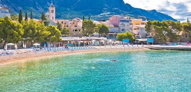Photo of panorama and landscape of Makarska resort and its harbour with boats and blue sea water, Croatia.