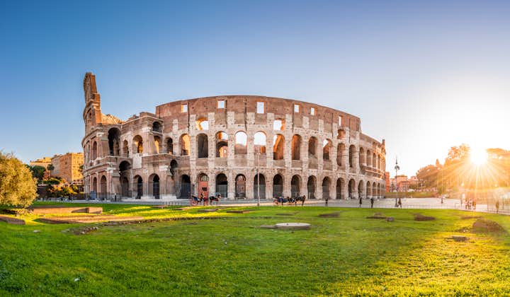 Panorama of Colosseum and Constantine arch at sunrise in Rome, Italy