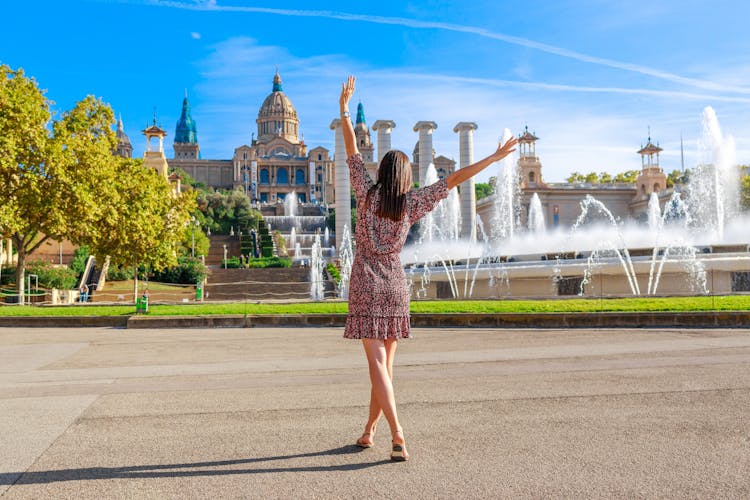 Photo of tourist woman on Montjuic hill. Populal sight in Barcelona, Spain.