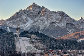 photo of an aerial view of Innsbruck, Austria during the winter morning, with snow and mountains at the background.