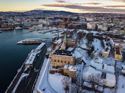 Photo of landscape with mountains, river and buildings in Lillehammer town, Norway.