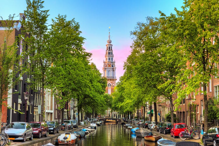 Beautiful Groenburgwal canal in Amsterdam with the Soutern church (Zuiderkerk) at sunset in summer.
