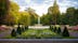 photo of flower arrangements in symmetrical shapes leading up to a fountain in the city park Stadsparken in the town Lund, Sweden.