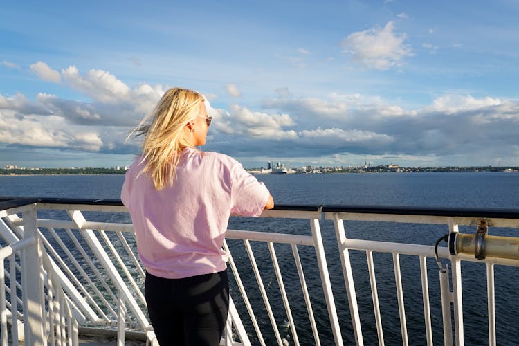 Photo of a tourist on the deck of a ship sailing from Tallinn.