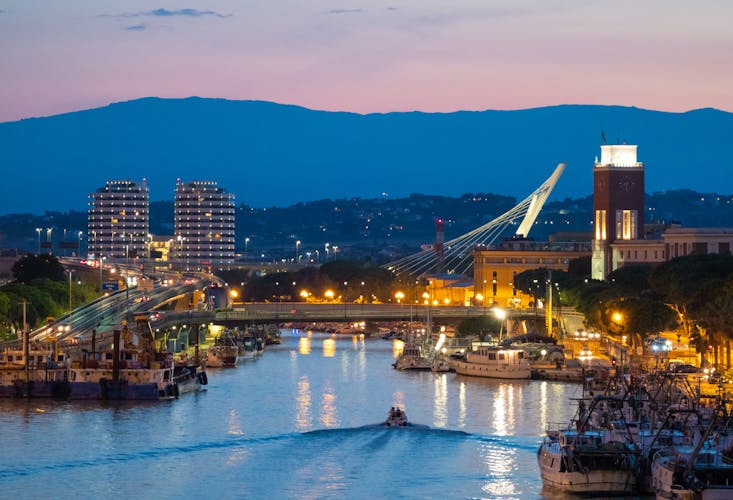The view in the dusk from Ponte del Mare monumental bridge in the canal and port of Pescara city, Abruzzo region.