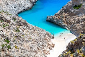 Photo of aerial view of black Perissa beach with beautiful turquoise water, sea waves and straw umbrellas, Greece.
