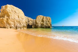 Photo of wide sandy beach in white city of Albufeira, Algarve, Portugal.