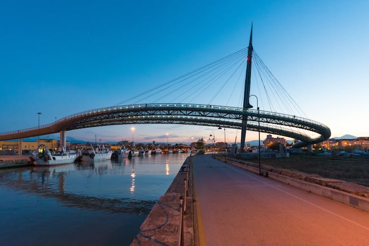 The Ponte del Mare monumental bridge and the Ferris wheel at the dusk, in the canal and port of Pescara city, Abruzzo region