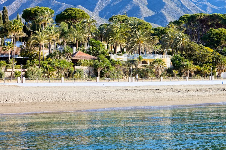 Photo of Marbella sandy beach coastline summer holiday scenery by the Mediterranean Sea in Spain,  Malaga province.