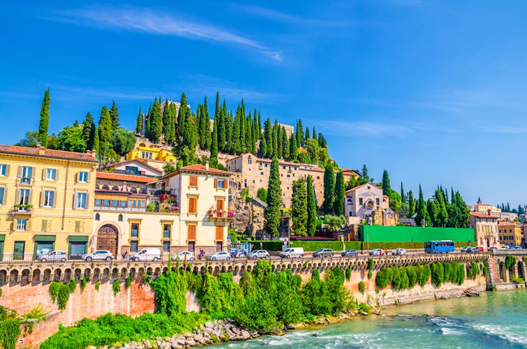Castel San Pietro St. Peter Castle, Museo Archeologico, Convento di San Girolamo on hill with cypress trees and Adige river in Verona city historical centre, blue sky, Veneto Region, Northern Italy.