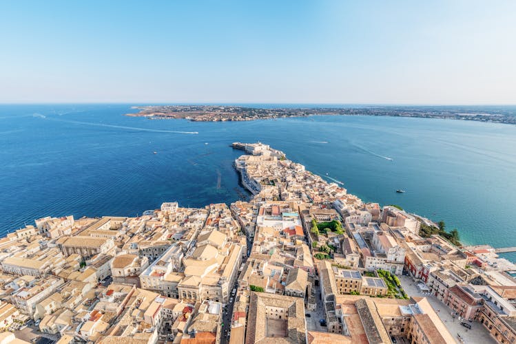 Photo of aerial view of the coastline town Syracuse Sicily and old Ortigia island.