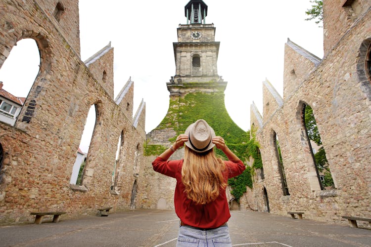 Photo of tourist girl visiting the ruins of the church of Aegidienkirche  in Hanover, Germany.